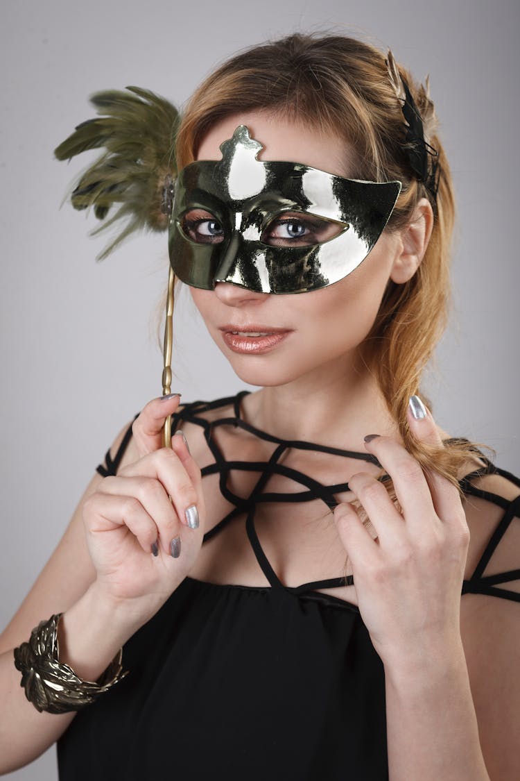 Woman Covering Face With Masquerade Mask