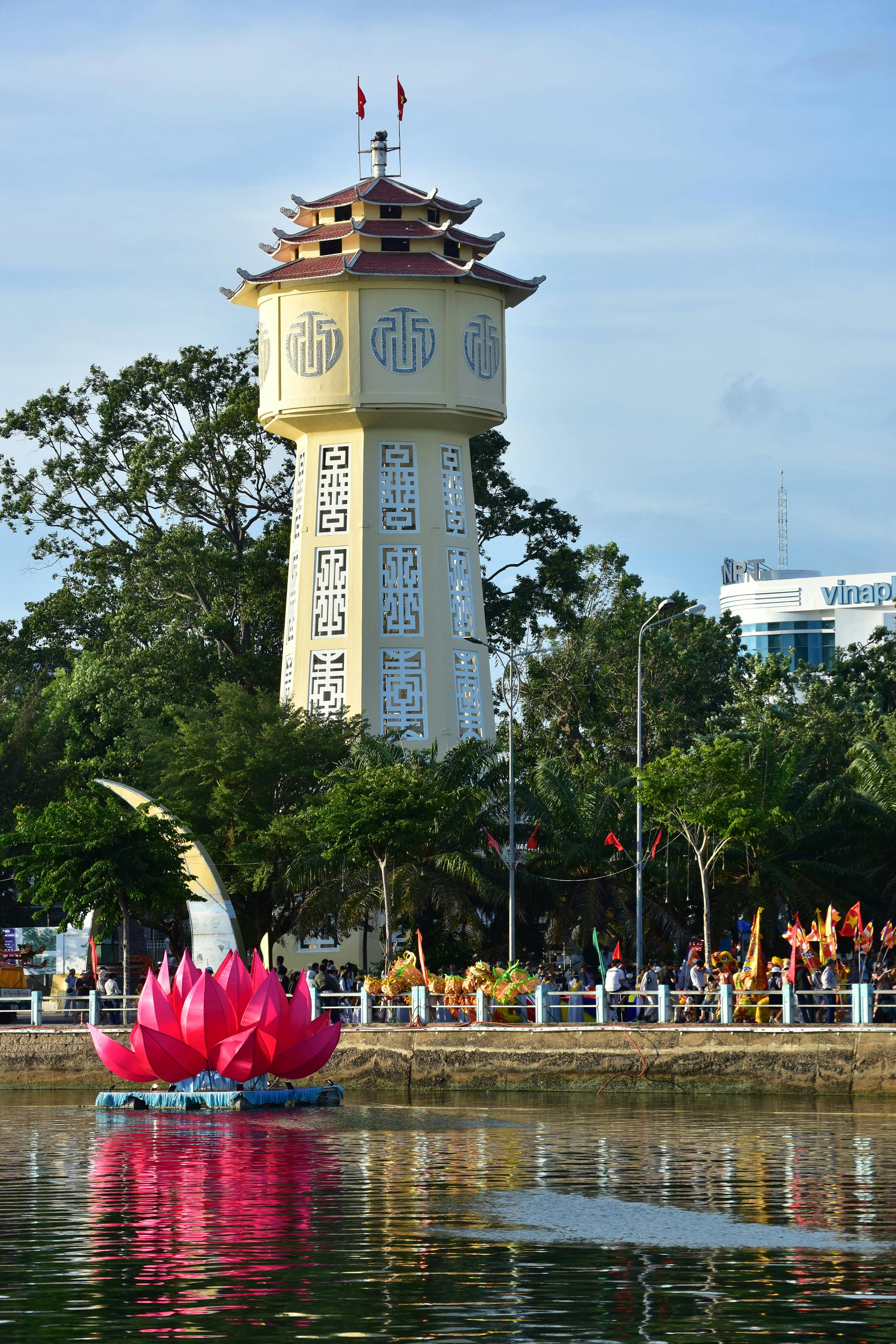 Scenic view of Phan Thiet Water Tower beside a lotus structure, reflecting Vietnamese architectural style.
