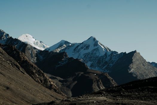 Captivating view of snow-covered Himalayan mountains against a clear morning sky.