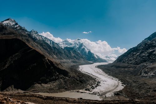 Free Breathtaking view of a glacier winding through the majestic Himalayan mountains under a clear blue sky. Stock Photo