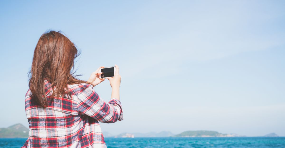 Tourist taking photo at filming location from popular TV show, scenic view