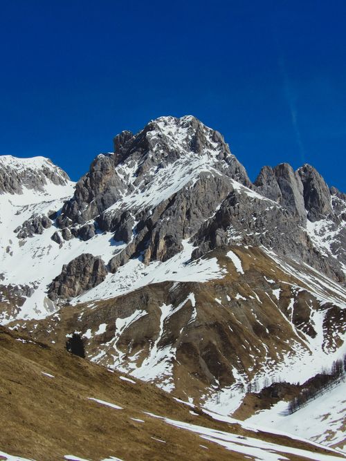 Free Snow-capped mountains under a clear blue sky in Trentino-Alto Adige, Italy. Stock Photo