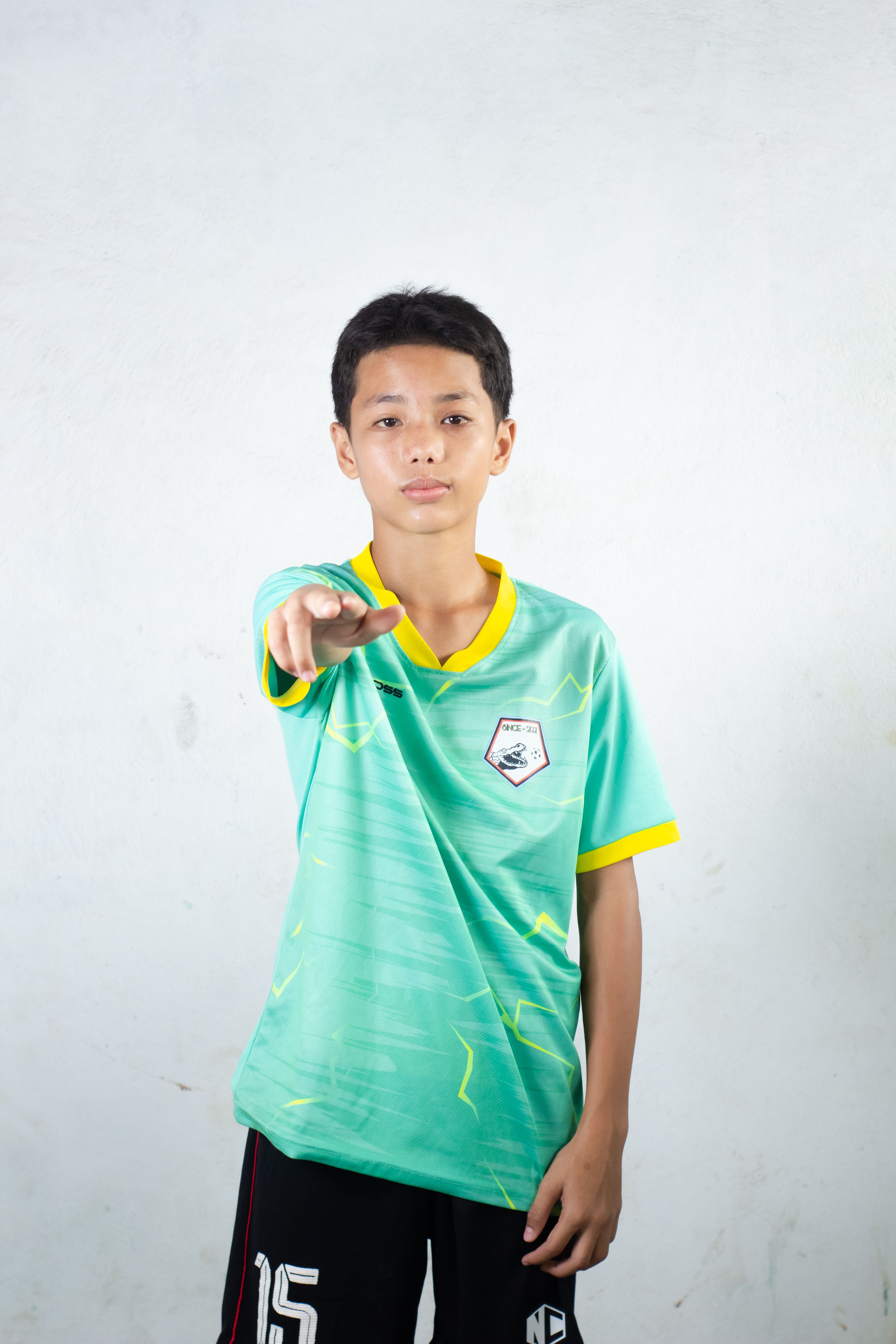Teenager in Sports Jersey Pointing Forward