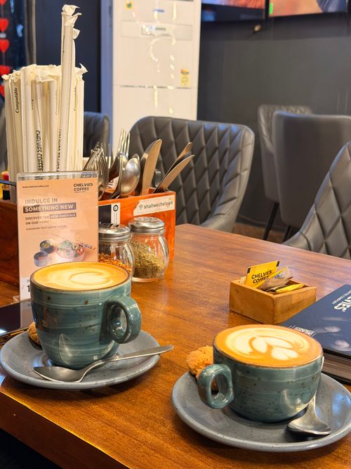 Free Warm and inviting photo capturing two lattes with heart latte art in a cafe setting. Stock Photo