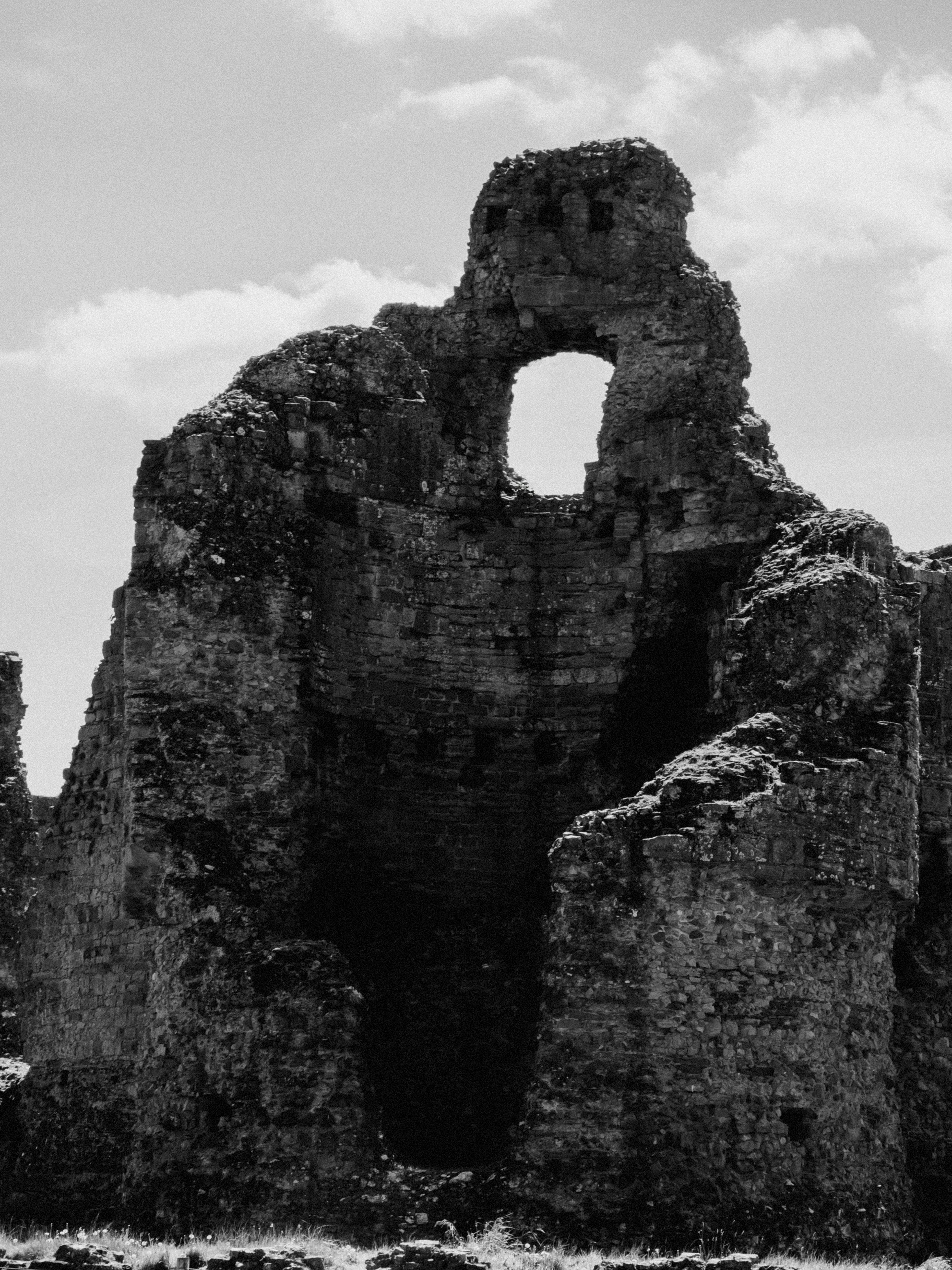 Historic stone ruin structure under clear sky, perfect for travel imagery.