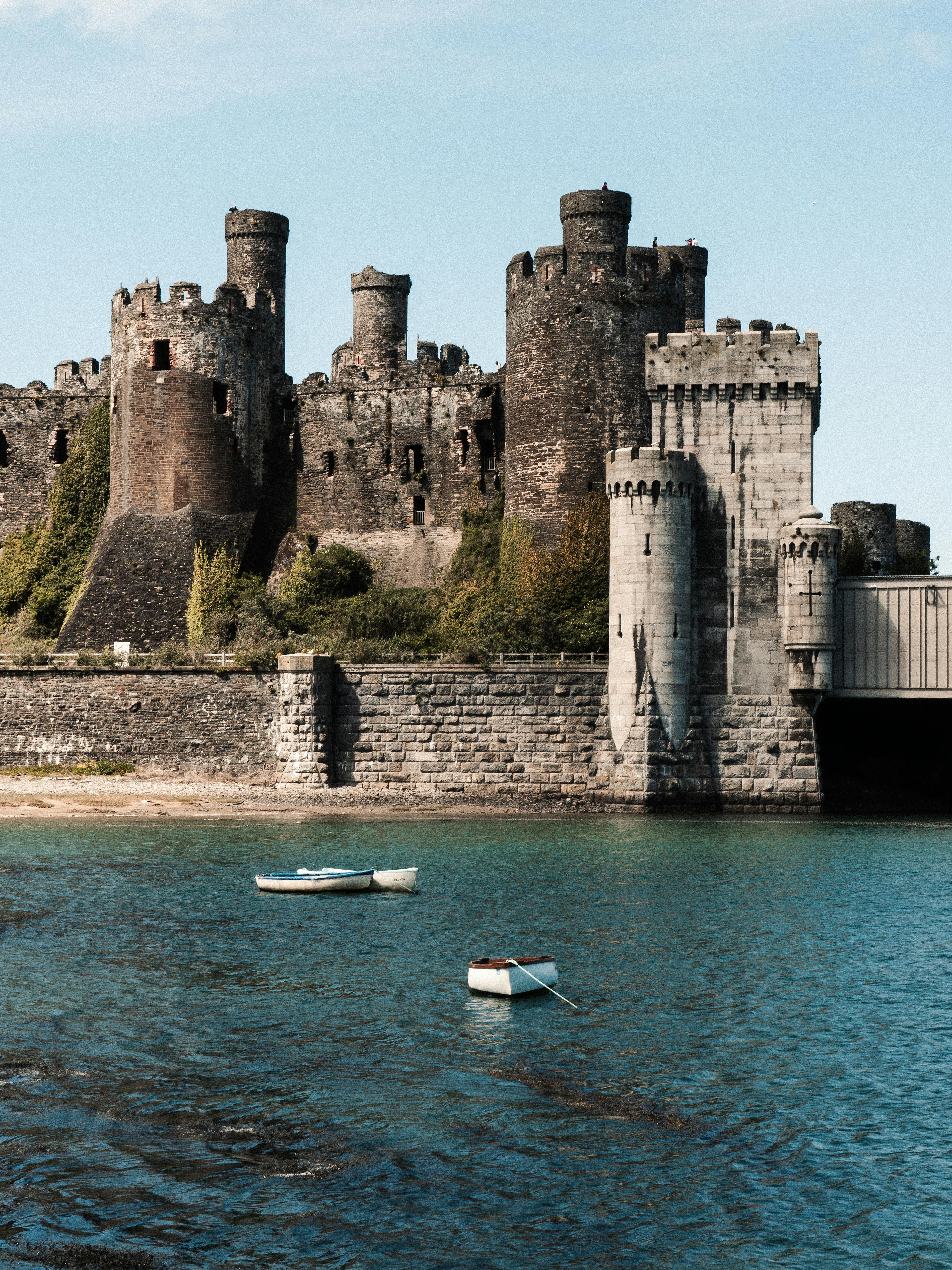 Conwy Castle in Wales with serene water view, perfect for travel or history themes.