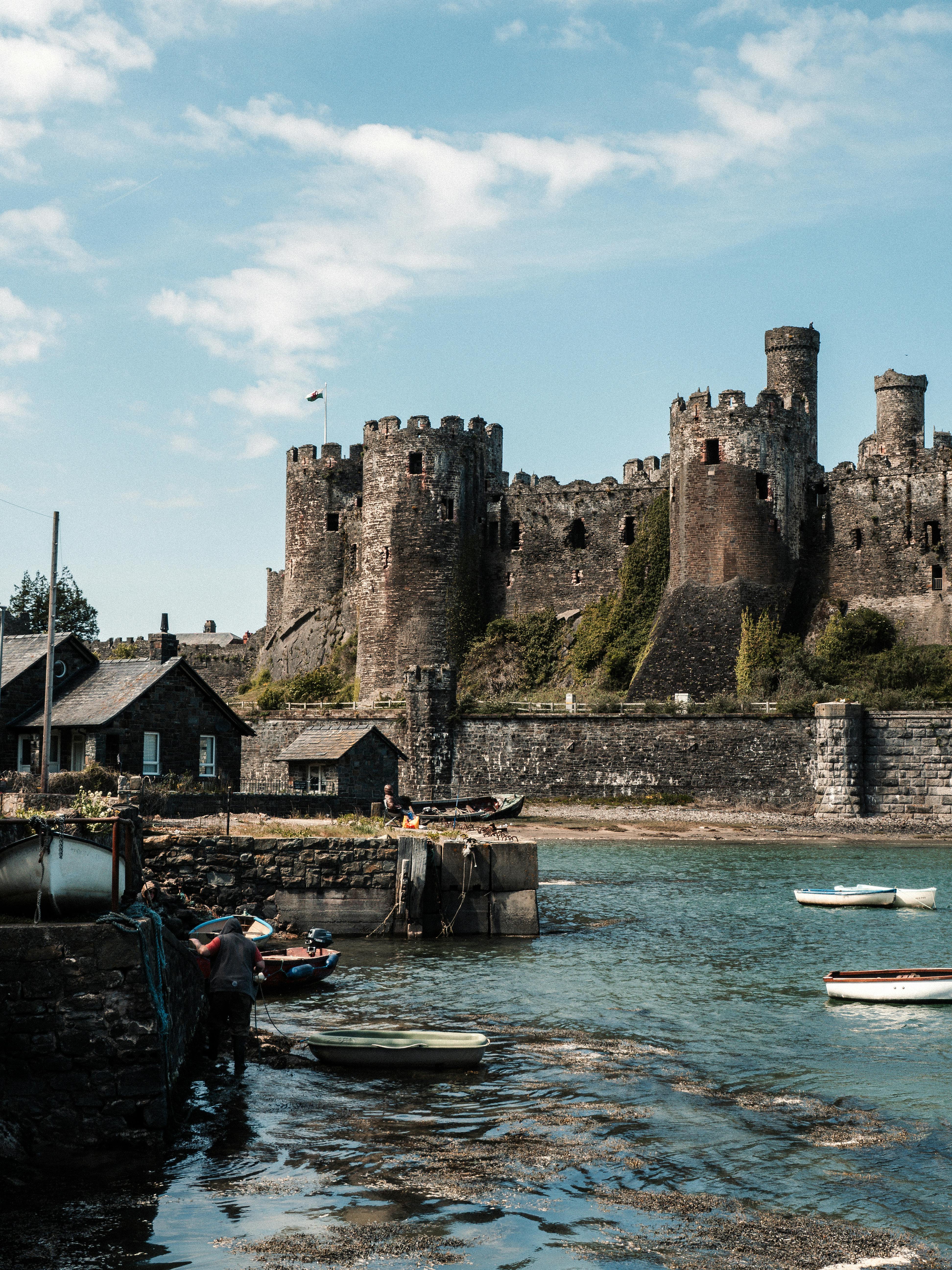 Explore the historic Conwy Castle overlooking the tranquil waterfront in Conwy, Wales.