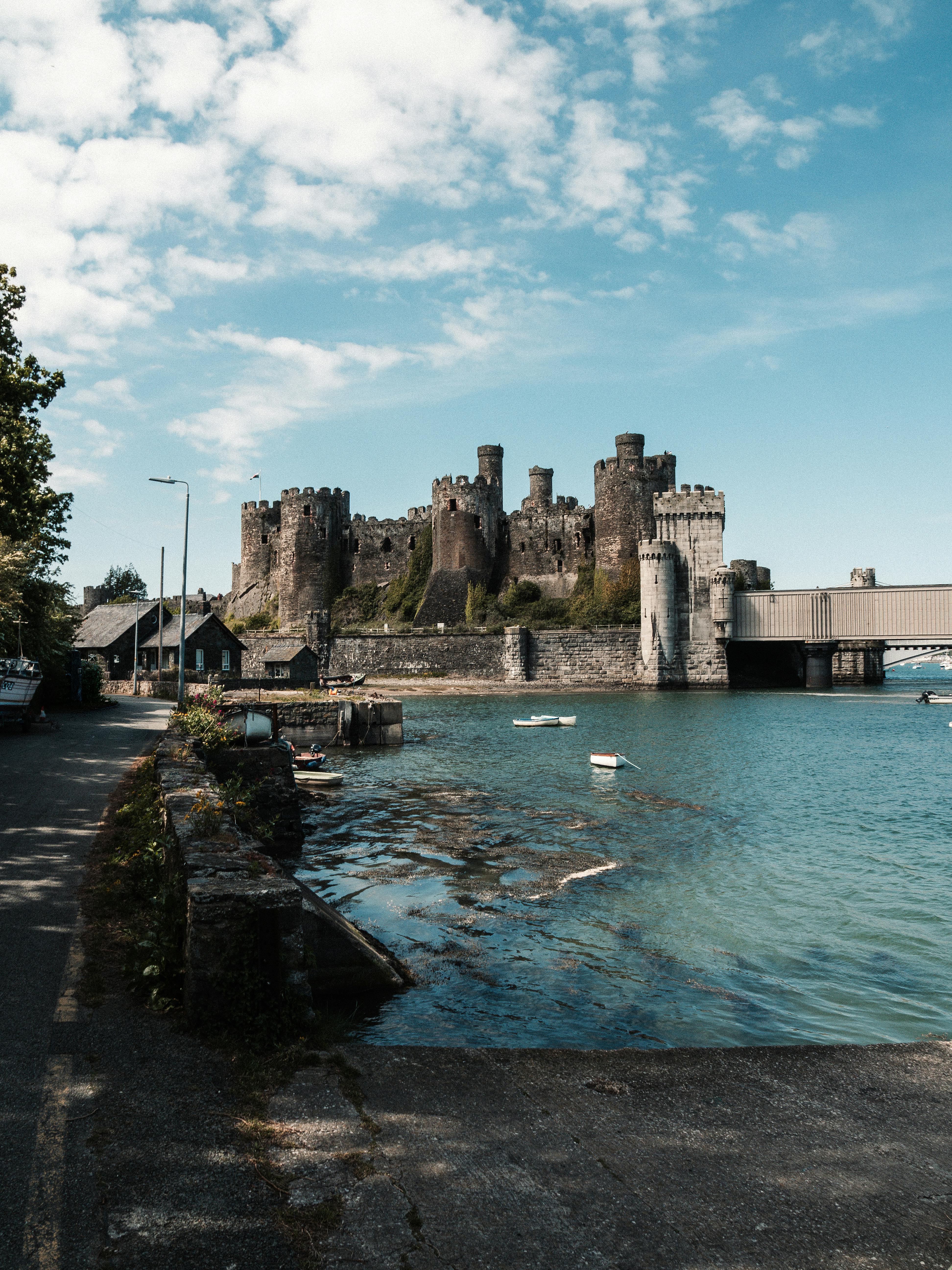 A captivating view of Conwy Castle, a historic fortress in Wales, with a serene riverfront.