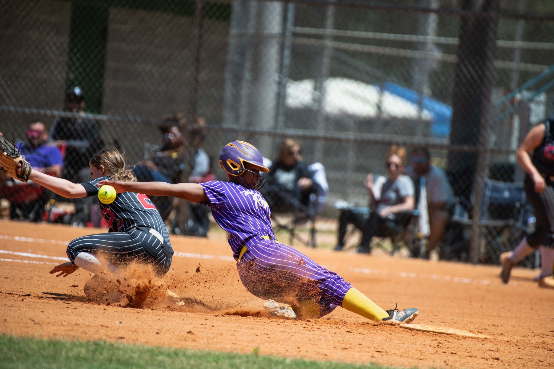 Softball athletes competing in game action