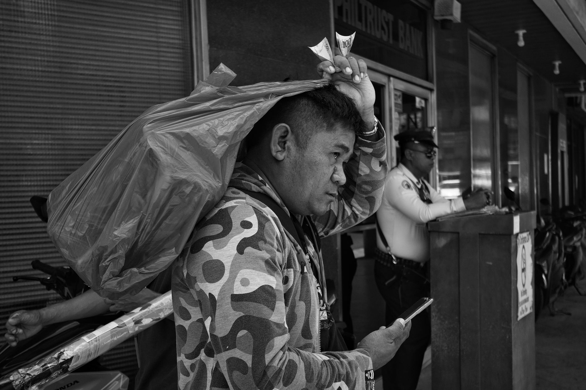 worried Filipino mobile user reviewing an unsuccessful withdrawal message beside bank transaction records