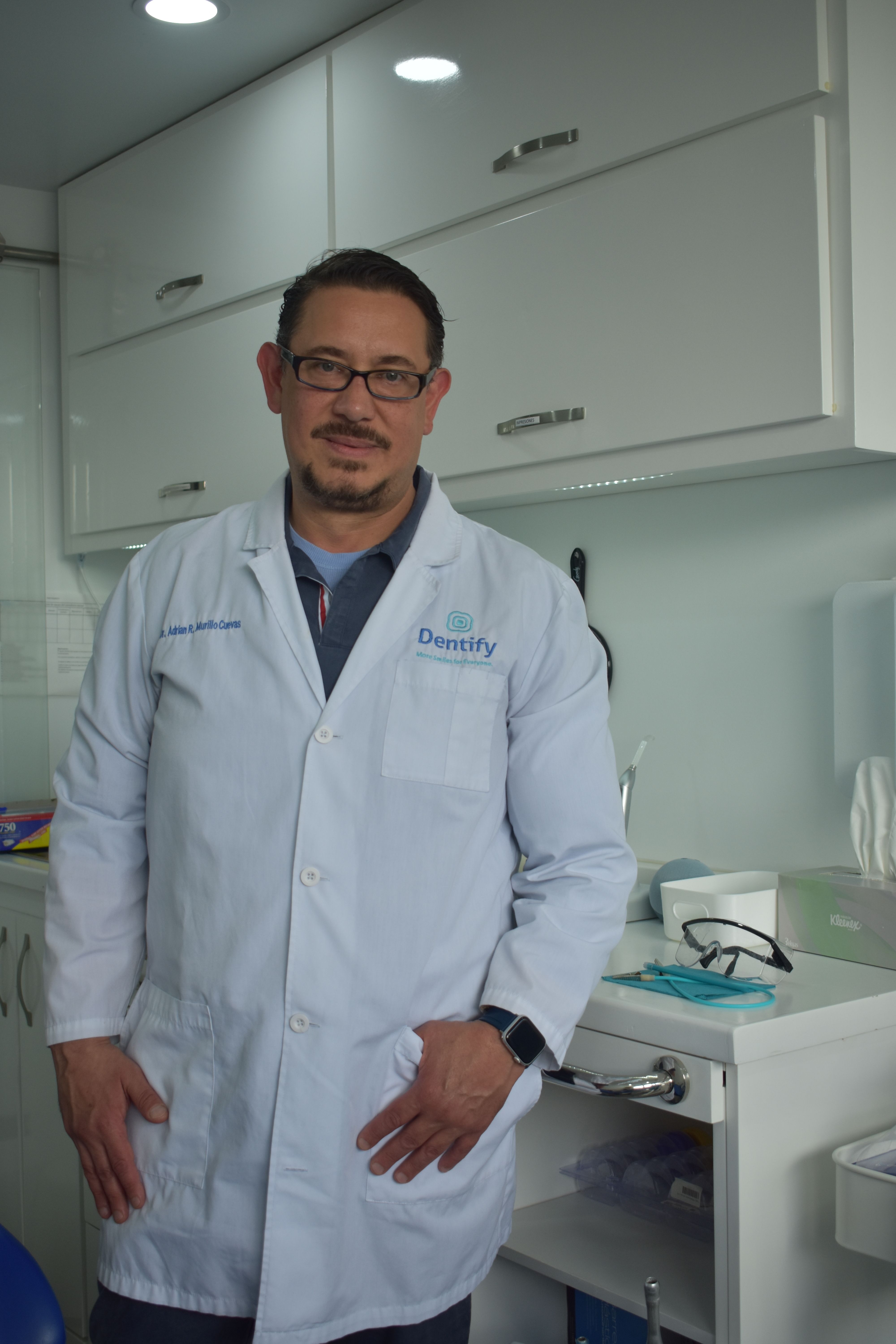 Portrait of a confident dentist in a modern clinic setting, offering dental care services.