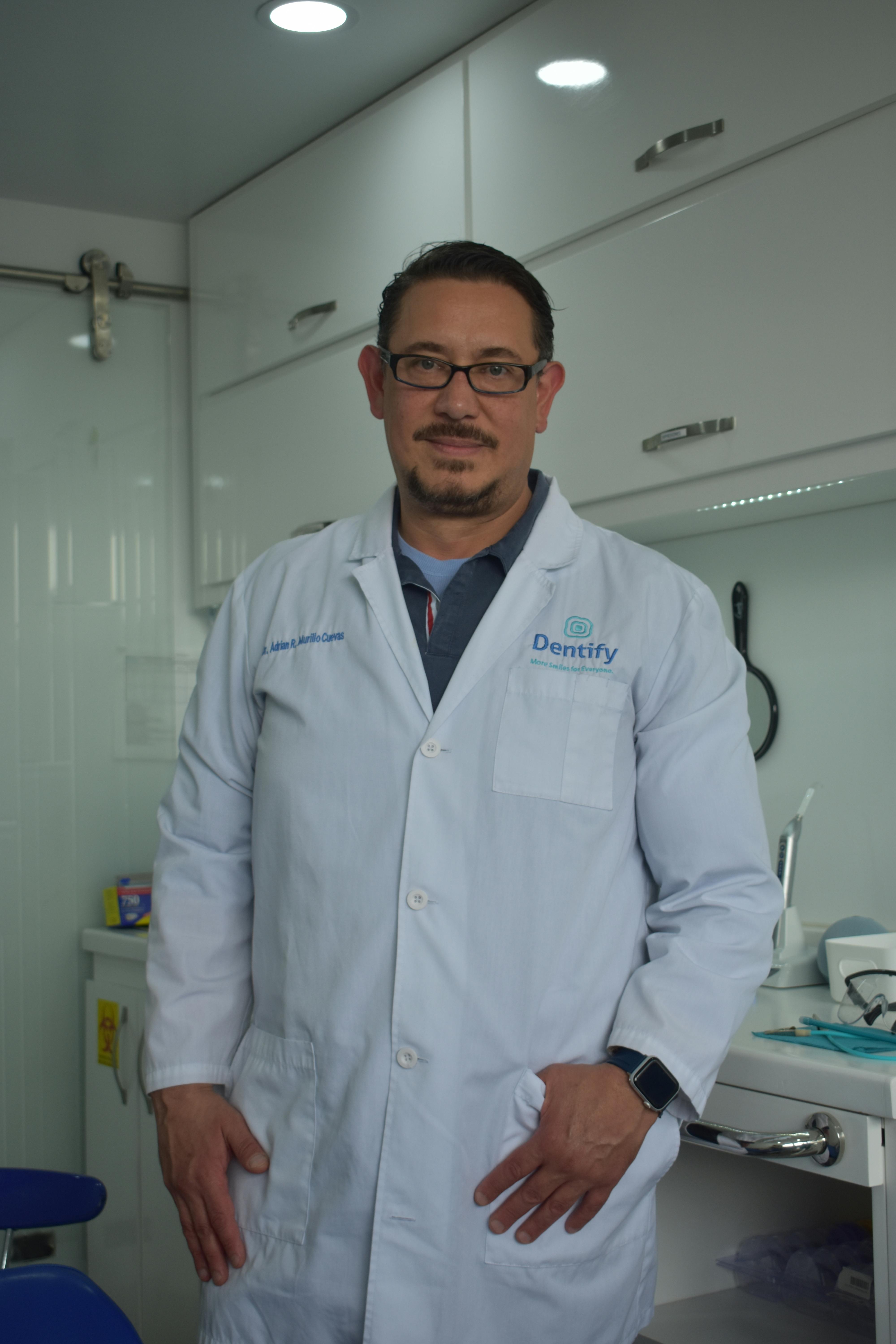 Male dentist in a modern dental clinic, showcasing a professional and welcoming environment.