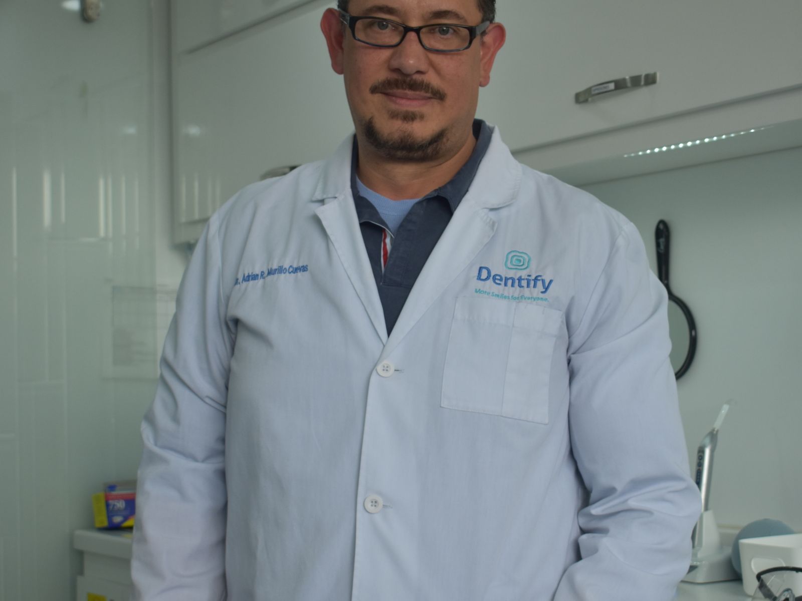 Smiling dental patient and clinician in a bright modern private dental clinic