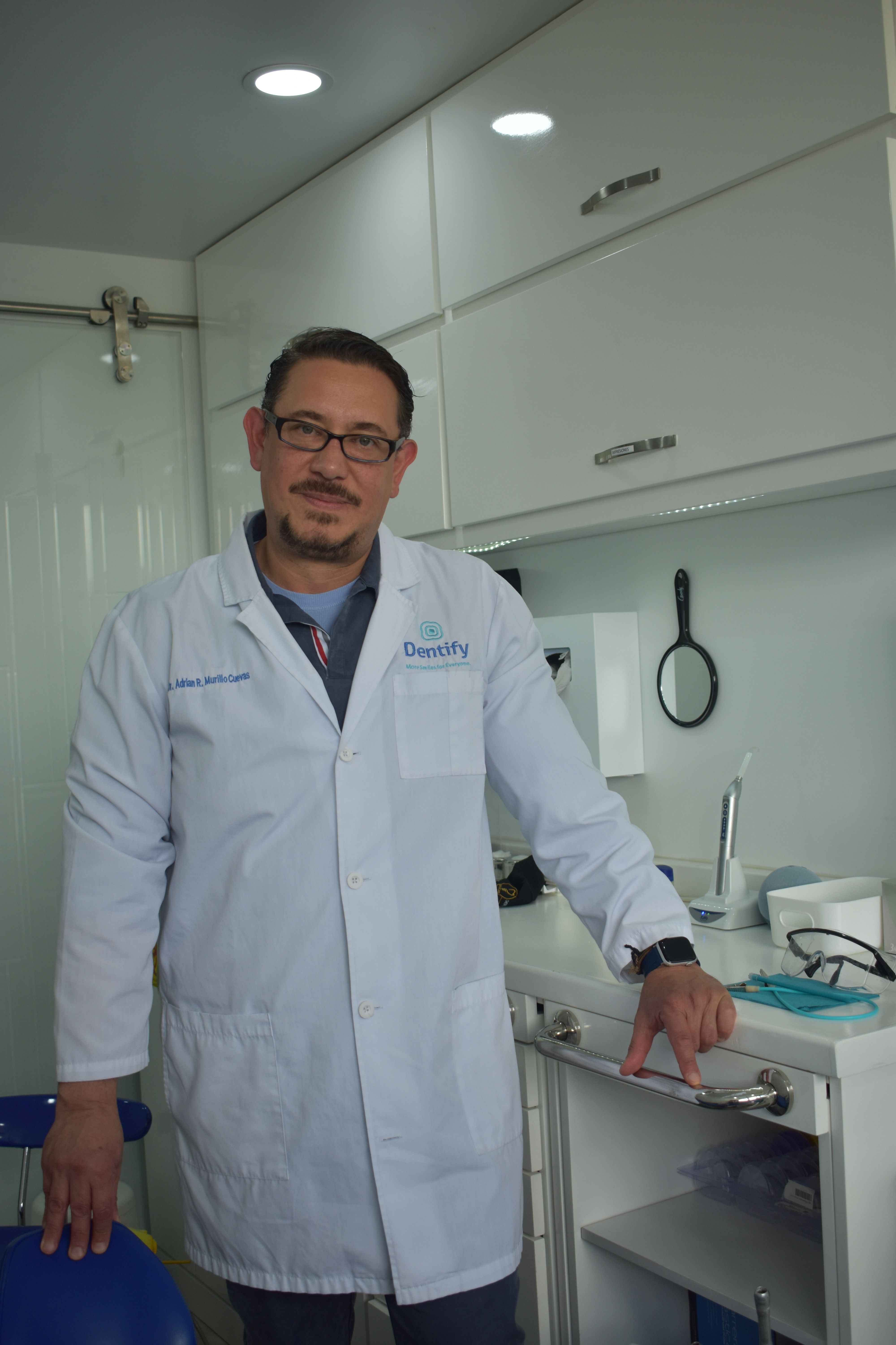 Smiling dental patient and clinician in a bright modern private dental clinic