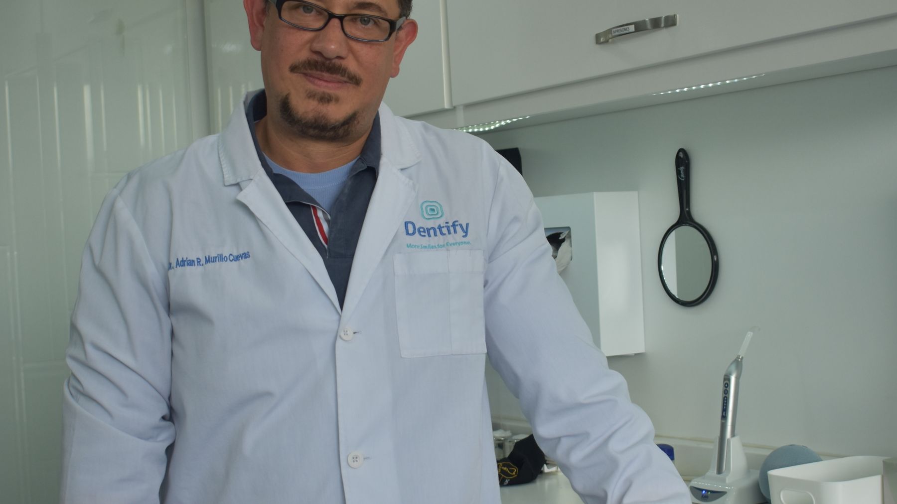 Smiling dental patient and clinician in a bright modern private dental clinic
