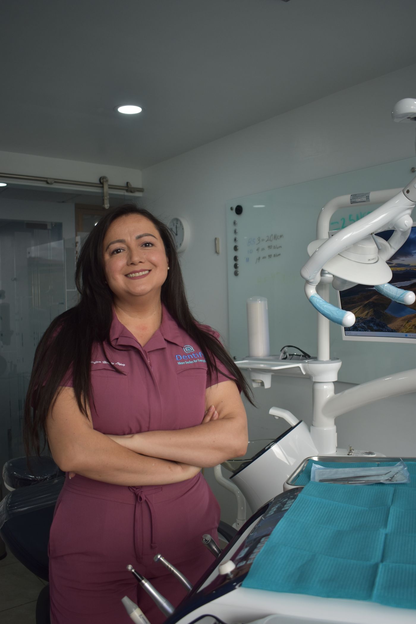 Dentist standing in her treatment room