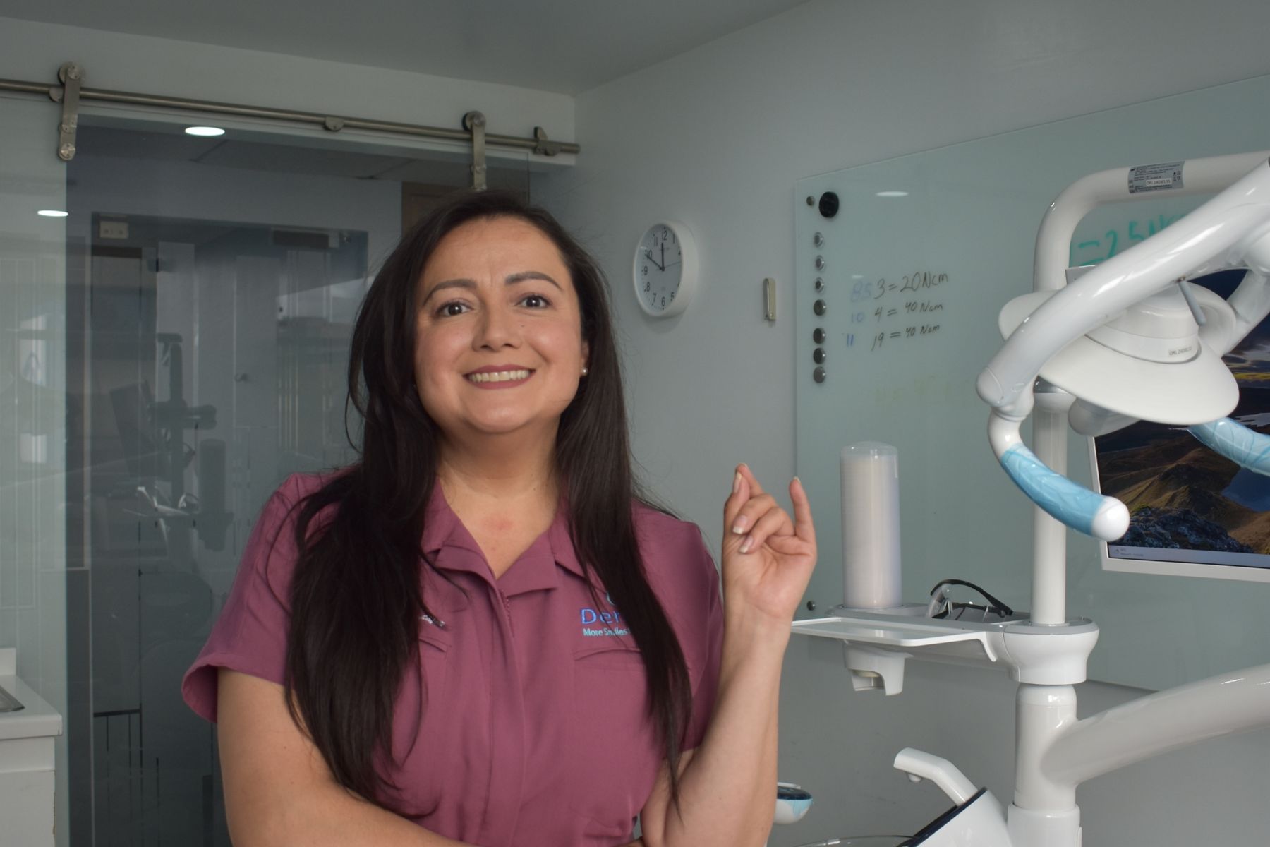 Smiling dental patient and clinician in a bright modern private dental clinic