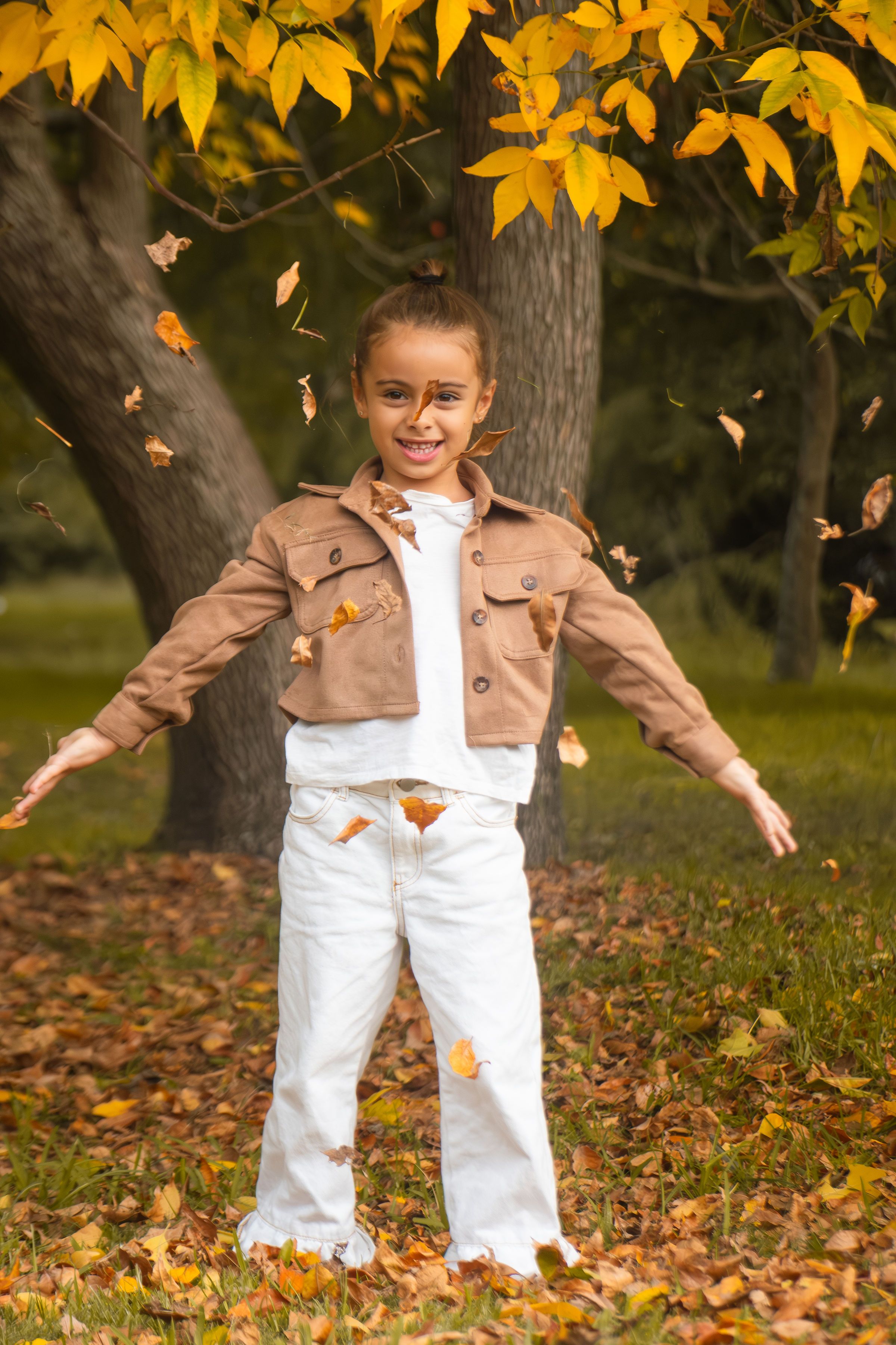 Child Playing with Autumn Leaves in Park · Free Stock Photo