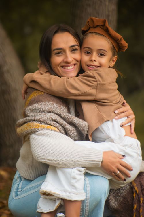 Free A joyful mother and daughter share a warm embrace outdoors, capturing a moment of love and happiness. Stock Photo