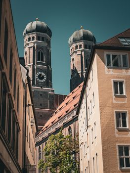 View of the Frauenkirche towers peeking through Munich's classic architecture.