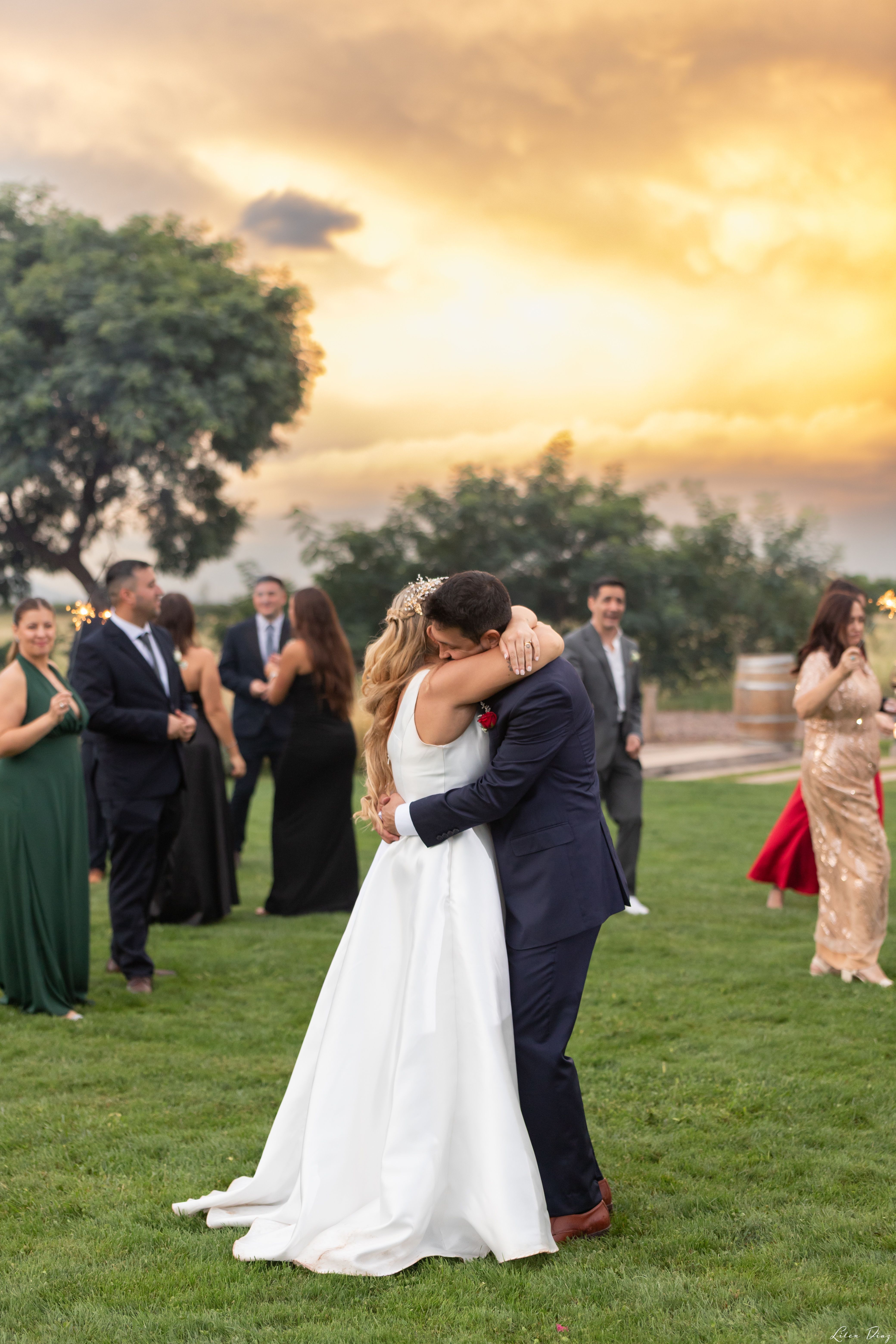 A couple shares a romantic embrace during their wedding dance at sunset in Mendoza, Argentina.