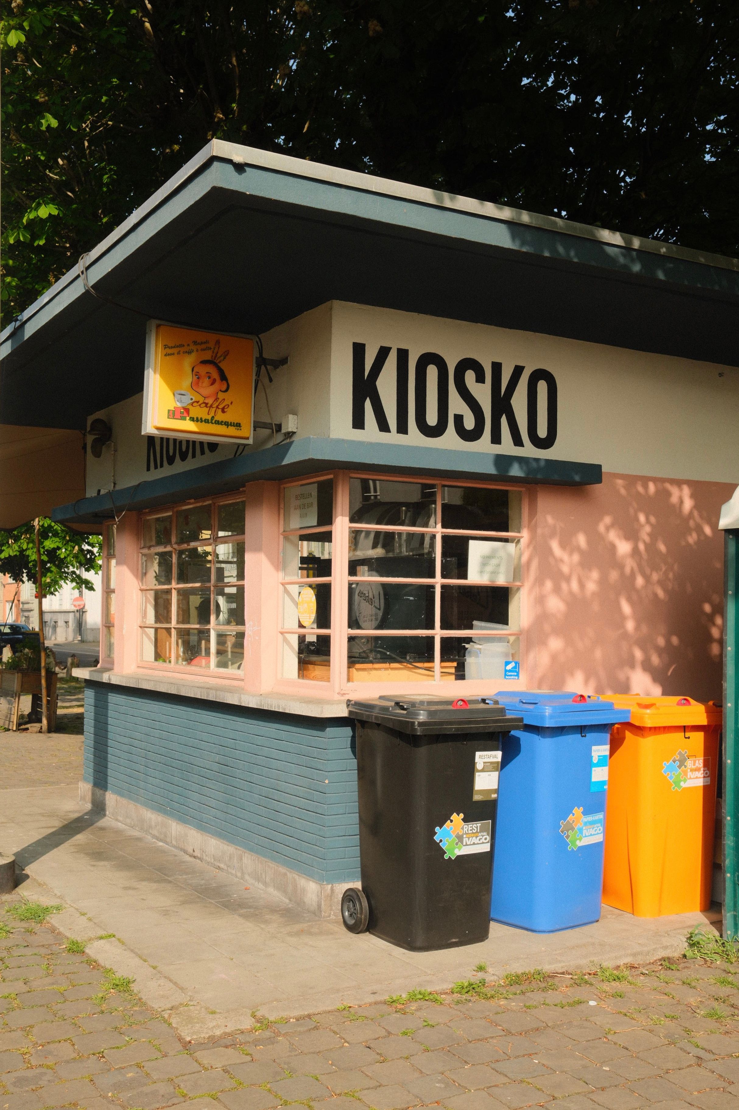 Colorful Kiosk with Recycling Bins Outdoors · Free Stock Photo