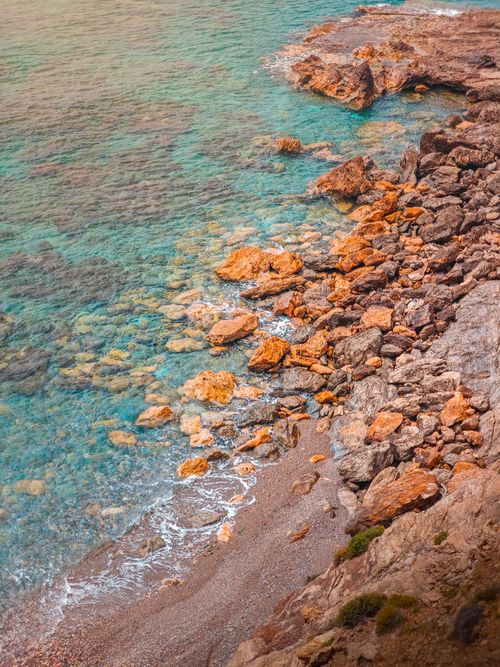 Free Explore the vibrant rocky shoreline of Gazipaşa, Turkey, with clear turquoise waters and colorful rocks. Stock Photo