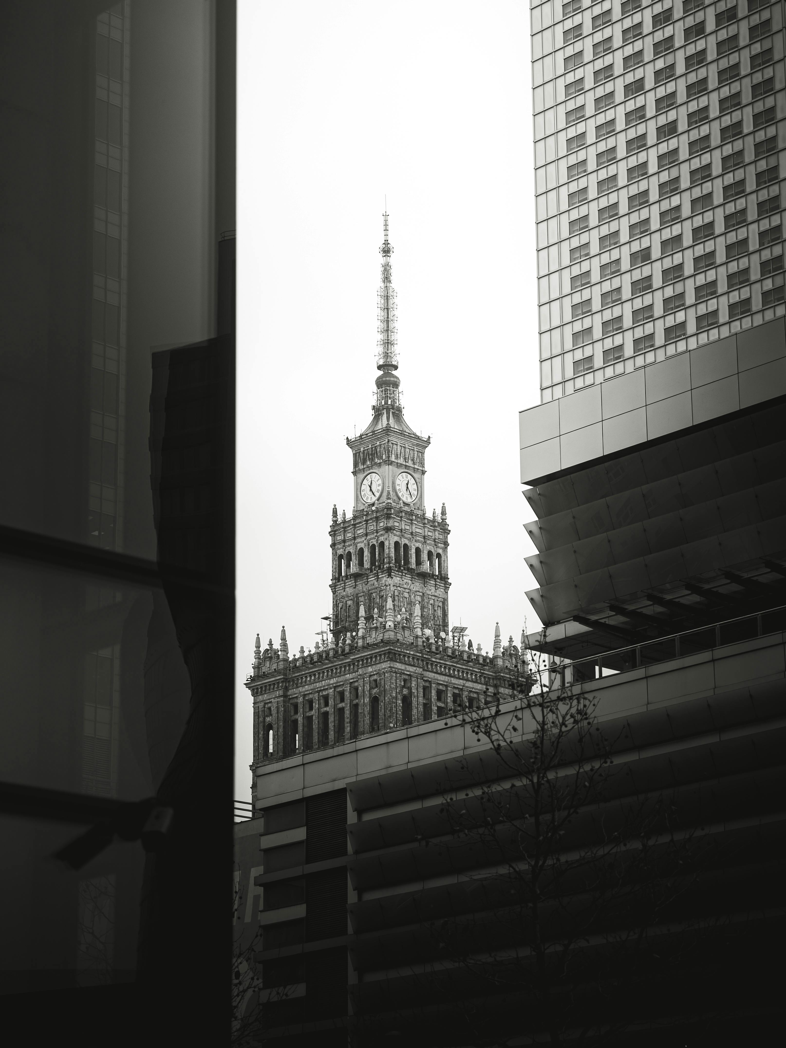 Striking monochrome view of a landmark tower framed by modern architecture.