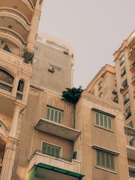 A vintage cityscape showcasing diverse architectural styles and textures under a pastel sky.
