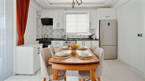 Free A modern kitchen interior with a clean dining table and elegant set up. Bright and spacious atmosphere. Stock Photo