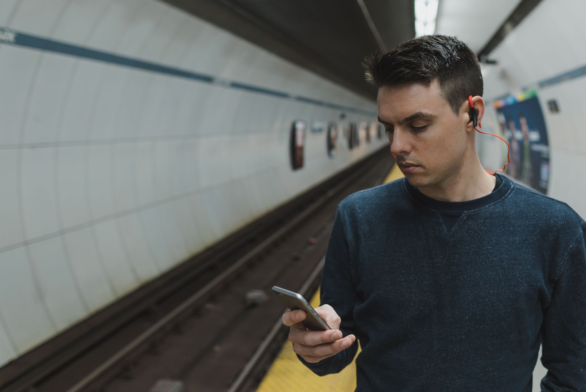 commuter checking transit app station platform