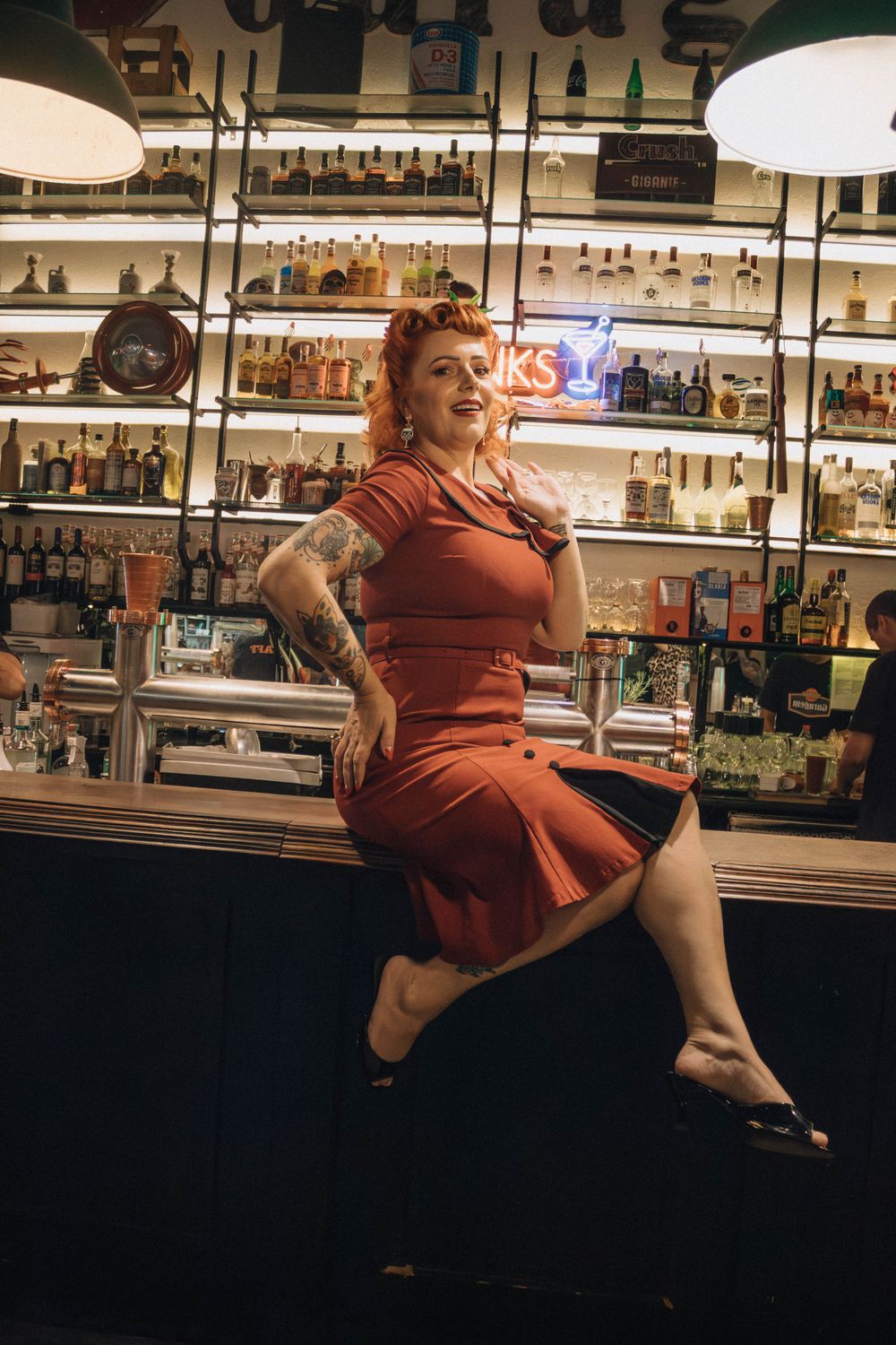 Woman in Red Dress Sitting on Bar Counter · Free Stock Photo