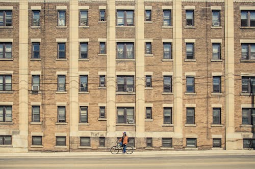 Person Biking Near Building