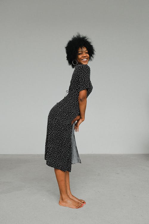 Woman in Black and White Polka Dot Dress Standing