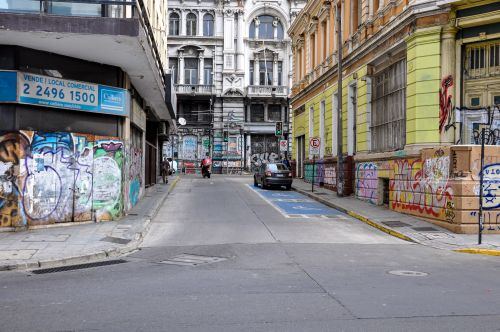 Free Vibrant urban street with graffiti-covered walls in Santiago's city center. Stock Photo