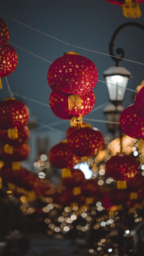 Free Vibrant red lanterns illuminate a street at night, creating a festive atmosphere. Stock Photo