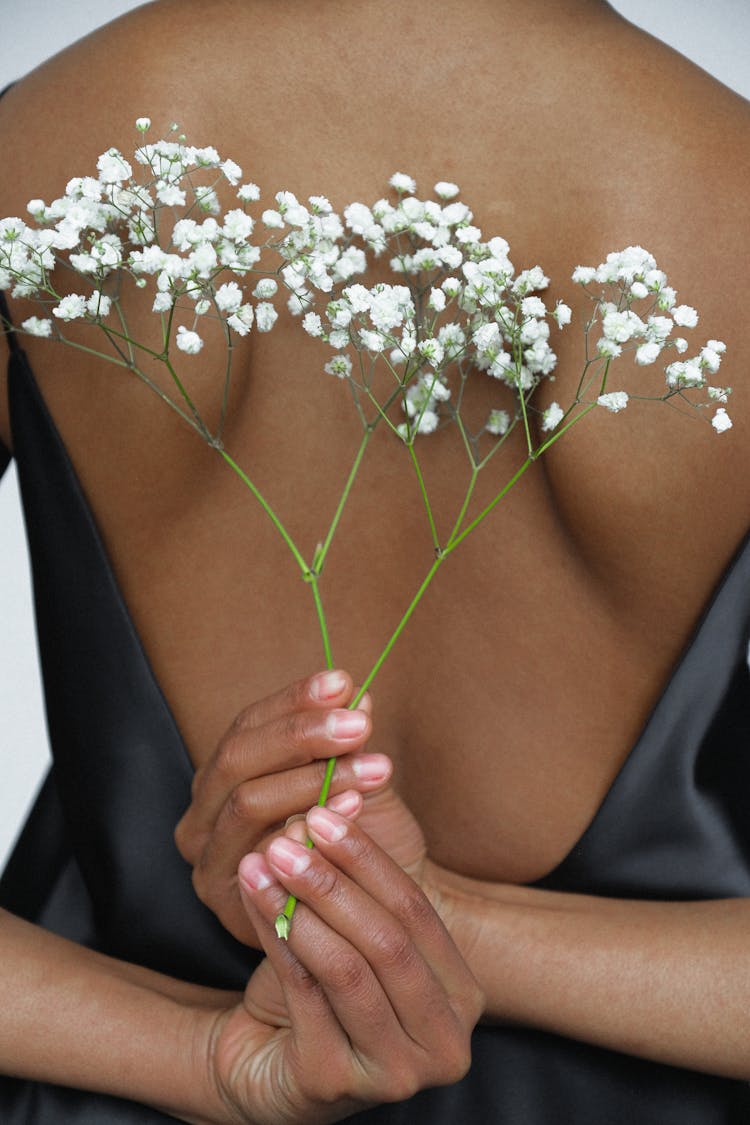 Close-up Photo Of Woman In Black Night Dress Holding White Flower Behind Her Back