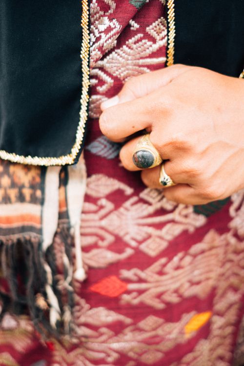 Free Detailed shot of a hand adorned with ethnic jewelry, featuring intricate fabric patterns. Stock Photo