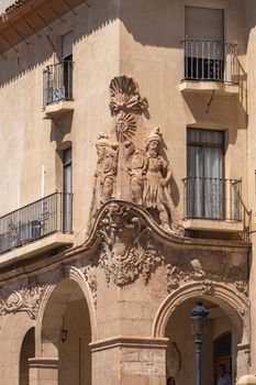 Detailed facade of historic building showcasing sculptures and arches in Lorca, Región de Murcia, Spain.