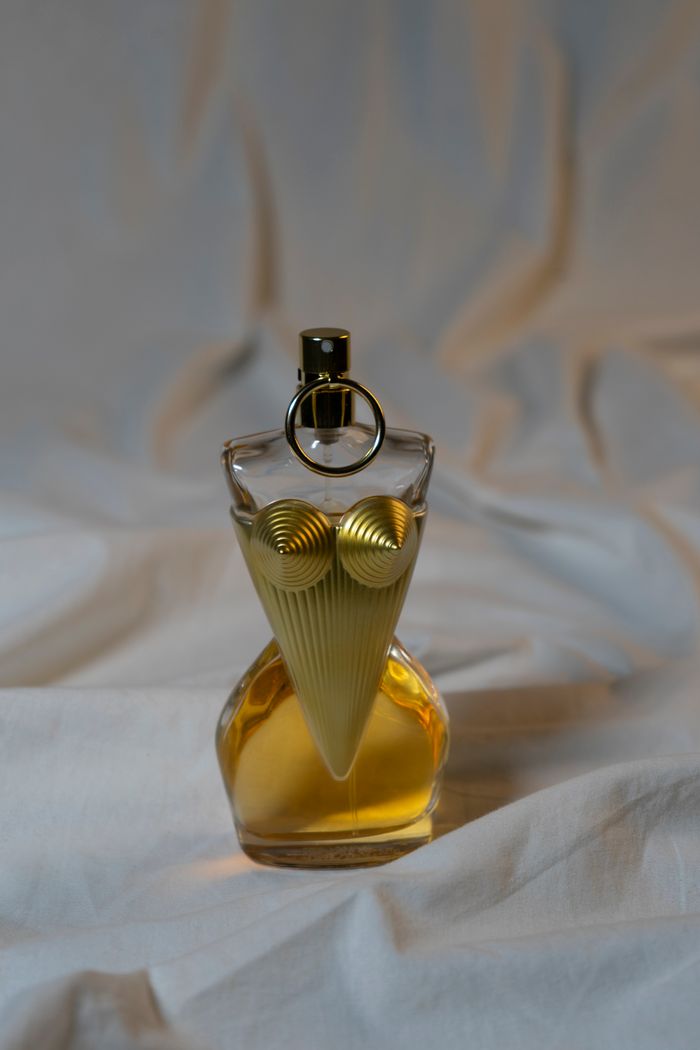 Golden perfume bottle on soft fabric