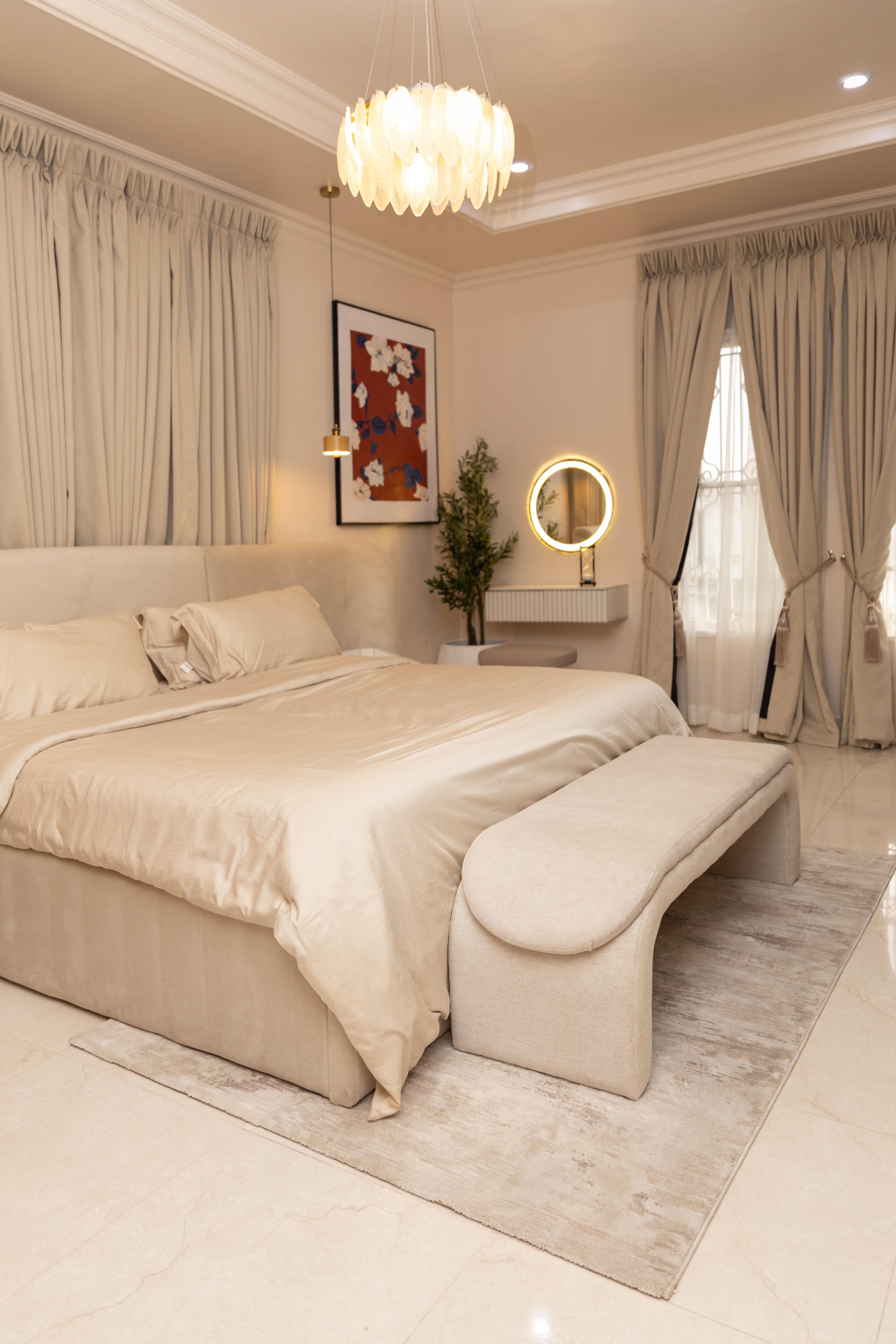Luxurious bedroom featuring a modern design with neutral tones and elegant decor.