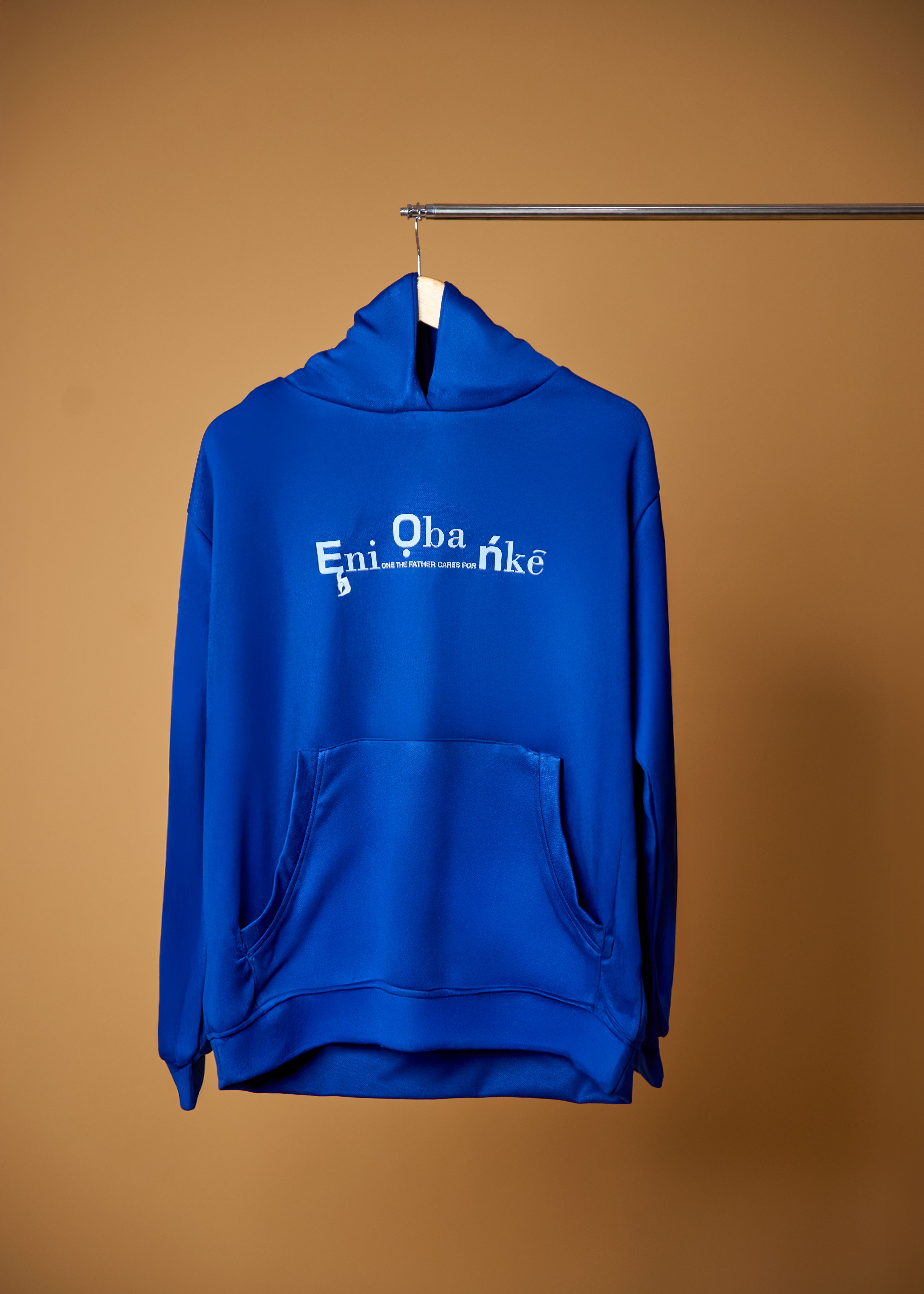 A vibrant blue hoodie with typography, displayed against a neutral background.