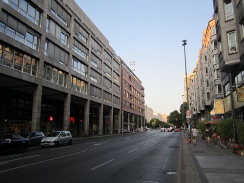 Free Street scene in Berlin, Germany, showcasing modern urban architecture during the evening. Stock Photo