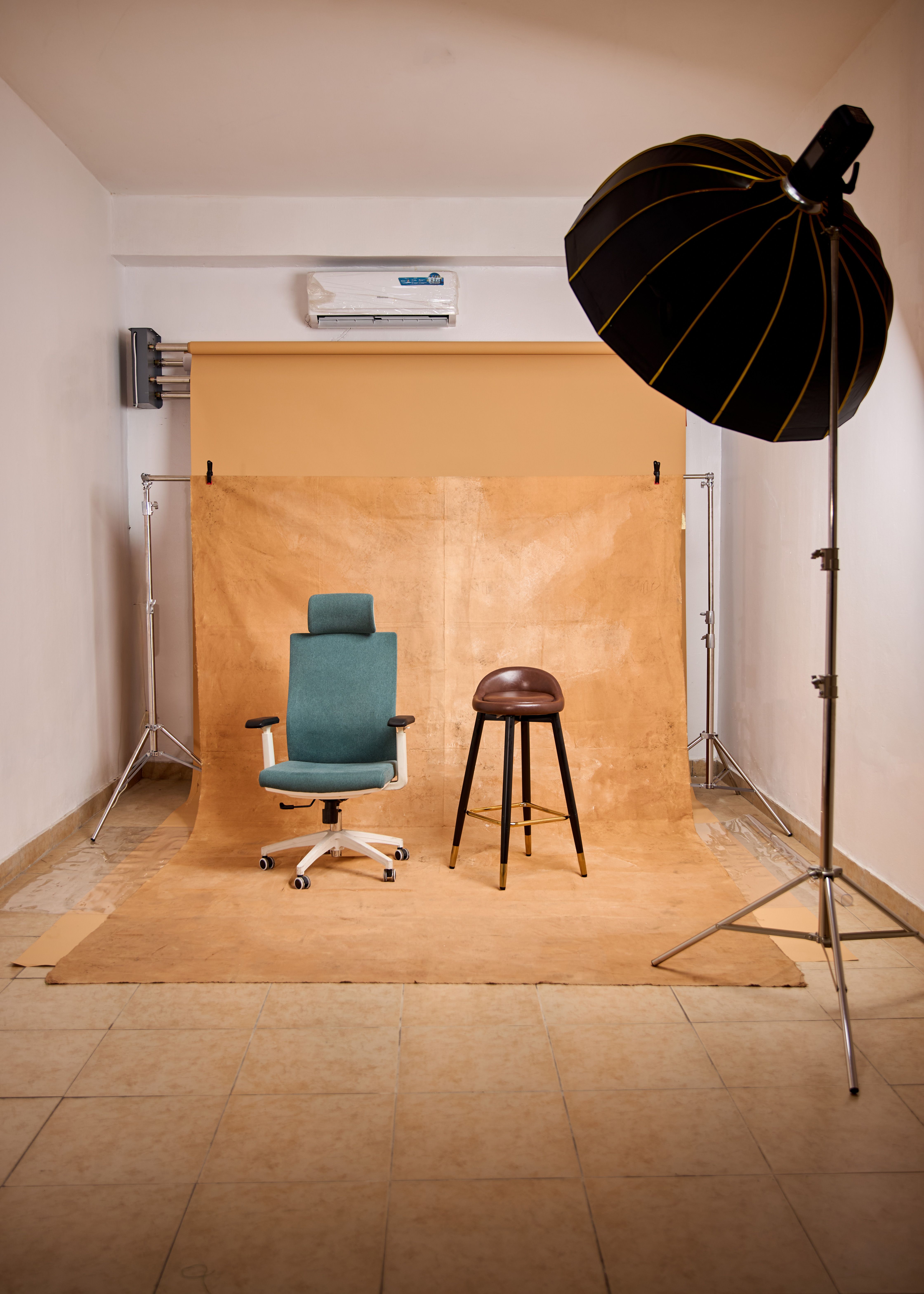 Interior view of a professional photo studio with chairs, lighting, and backdrop.