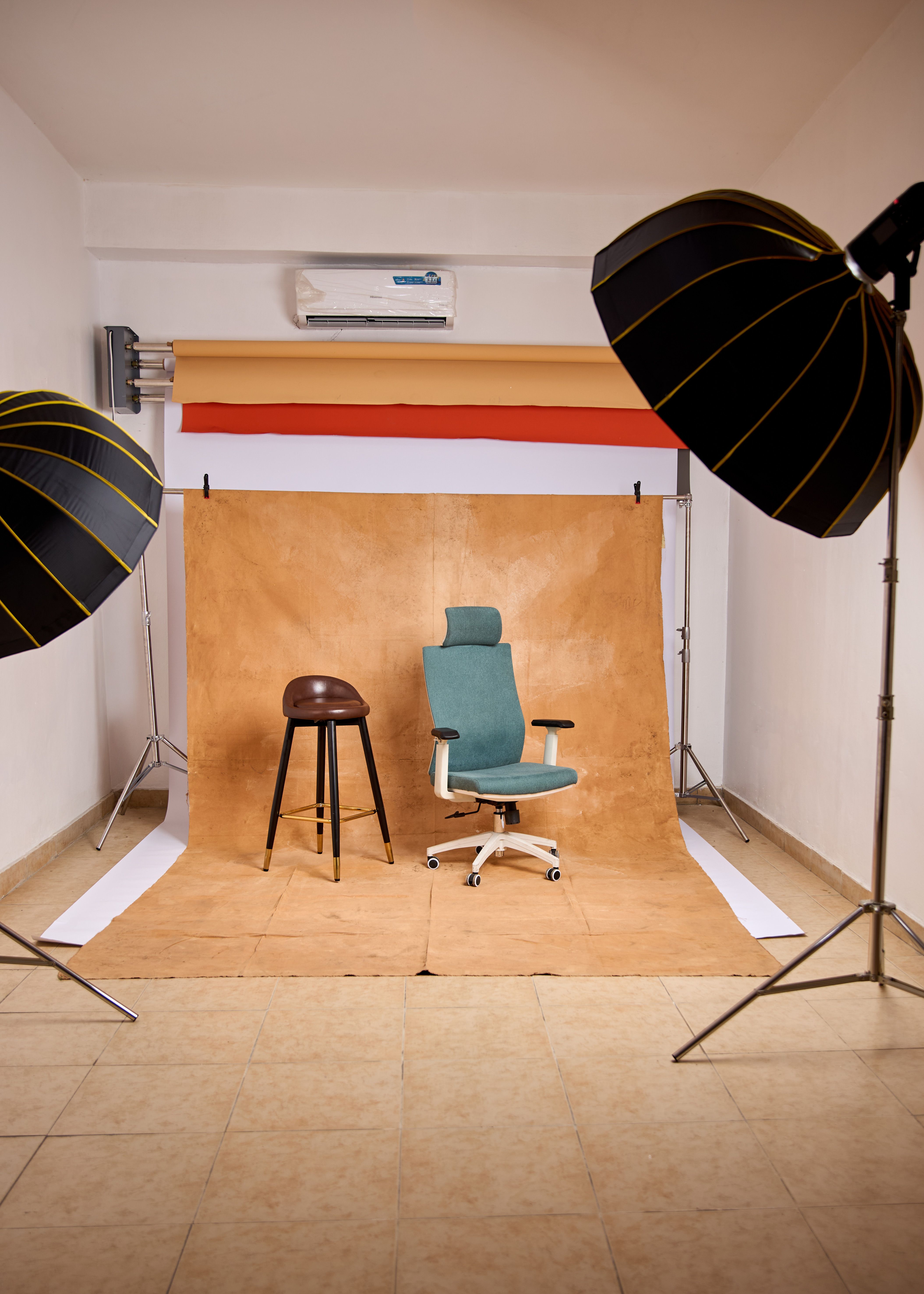 Interior view of a photo studio with chairs and lighting equipment.