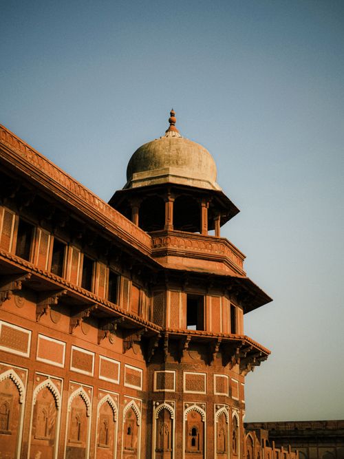 Free Capture of an ornate Mughal architecture building at sunrise, showcasing intricate design and historical grandeur. Stock Photo