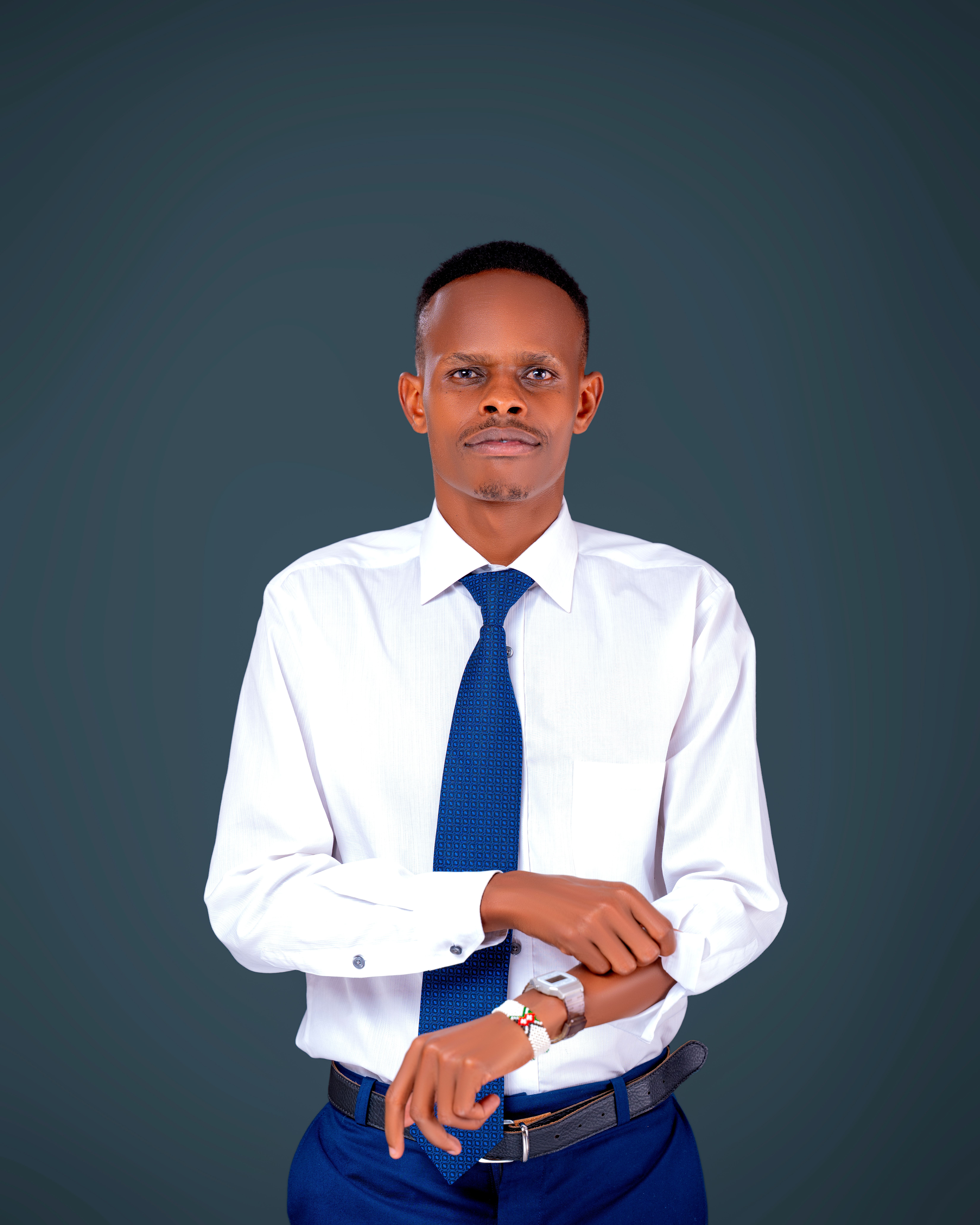 Elegant businessman in formal attire adjusting watch, looking confident against neutral background.