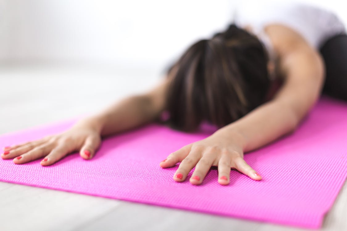 Woman Exercising on Yoga Mat