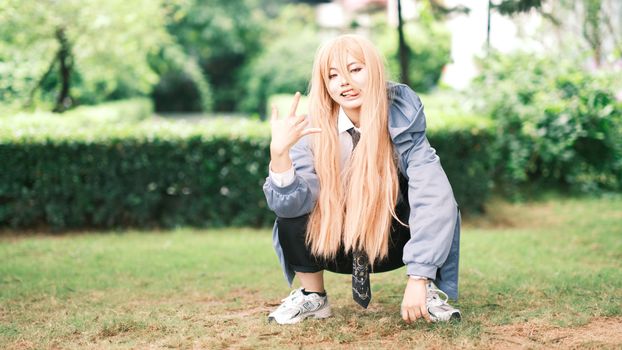 Stylish young adult posing outdoors in casual attire, showcasing unique fashion sense.