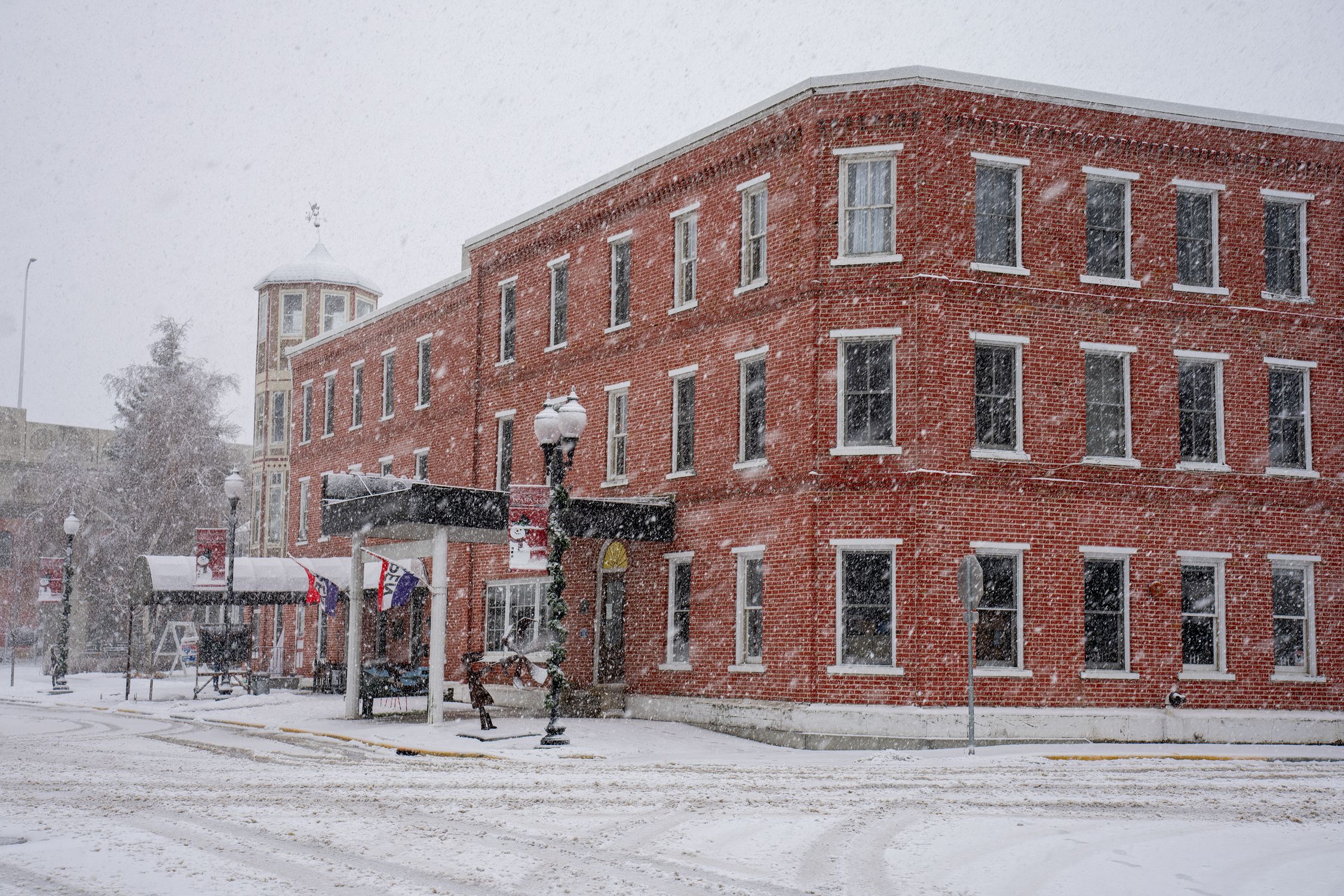 Charming winter scene of snowfall covering a historic brick building in Wabasha, Minnesota.